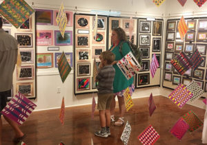 mother and son visiting a student art exhibit